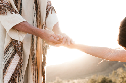 Photo of Jesus holding a woman's hand